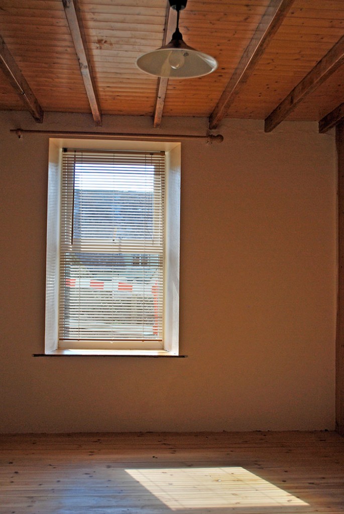 Living room, with restored original wooden beams & partition. Insulated floor & double glazing.